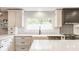 Sun-drenched kitchen showcases white subway tile backsplash and stainless steel appliances at 654 E 79Th St, Indianapolis, IN 46240