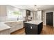 Bright eat-in kitchen features a large window, white cabinets, and a black island at 654 E 79Th St, Indianapolis, IN 46240
