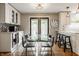 Kitchen and dining area, featuring stainless steel beverage cooler and access to deck at 654 E 79Th St, Indianapolis, IN 46240