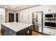 Spacious kitchen with stainless steel appliances, a quartz countertop island, and ample cabinet space at 654 E 79Th St, Indianapolis, IN 46240