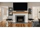Living room featuring a fireplace with a large TV and hardwood floors at 654 E 79Th St, Indianapolis, IN 46240