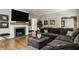 Comfortable living room features a stone fireplace, mounted TV, and hardwood floors at 654 E 79Th St, Indianapolis, IN 46240