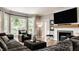 Bright living room with a large window, dark leather chair, and fireplace at 654 E 79Th St, Indianapolis, IN 46240