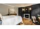 A luxurious bedroom with custom black built-ins surrounding a fireplace and hardwood floors at 654 E 79Th St, Indianapolis, IN 46240