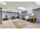 Spacious basement featuring a cozy entertainment area with a TV, decorative rug, and stylish furnishings at 7323 Elm Ridge Dr, Indianapolis, IN 46236