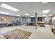 Finished basement includes a seating area, ping pong table, and a pool table, perfect for recreation at 7323 Elm Ridge Dr, Indianapolis, IN 46236