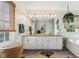 Bright bathroom with double vanity, large mirror, and a relaxing tub at 7323 Elm Ridge Dr, Indianapolis, IN 46236