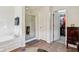 Bathroom featuring a glass enclosed shower and door to walk in closet at 7323 Elm Ridge Dr, Indianapolis, IN 46236