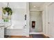 Bright bathroom featuring a glass enclosed shower, tub, and hanging plant at 7323 Elm Ridge Dr, Indianapolis, IN 46236