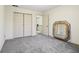 Bedroom with carpet, featuring a double door closet and a large, decorative mirror at 7323 Elm Ridge Dr, Indianapolis, IN 46236