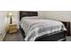 Comfortable bedroom with neutral tones, carpet, side table, and lamp at 7323 Elm Ridge Dr, Indianapolis, IN 46236