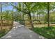 Picturesque wooden bridge with railing over a creek in a tranquil wooded area at 7323 Elm Ridge Dr, Indianapolis, IN 46236