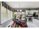 Bright dining area features large windows, chandelier lighting, and a round table with seating for six at 7323 Elm Ridge Dr, Indianapolis, IN 46236