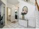 Entryway with marble floors, a decorative mirror, and a table with flowers at 7323 Elm Ridge Dr, Indianapolis, IN 46236