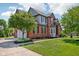 Well-maintained home with lush landscaping, a large driveway, and attached garage at 7323 Elm Ridge Dr, Indianapolis, IN 46236