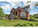 Beautiful brick home featuring manicured lawn and mature landscaping at 7323 Elm Ridge Dr, Indianapolis, IN 46236