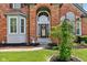 Close-up of brick entryway with decorative wreath and manicured landscaping at 7323 Elm Ridge Dr, Indianapolis, IN 46236