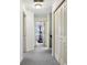 Hallway leading to various rooms, enhanced by neutral carpet and white walls at 7323 Elm Ridge Dr, Indianapolis, IN 46236