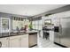 Bright kitchen featuring stainless steel appliances, granite countertops and a tiled floor at 7323 Elm Ridge Dr, Indianapolis, IN 46236