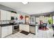 Well-lit kitchen with stainless steel appliances and granite countertops, open to the dining area with a round table at 7323 Elm Ridge Dr, Indianapolis, IN 46236
