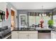 Bright kitchen with granite countertops, stainless appliances and a view to the dining area at 7323 Elm Ridge Dr, Indianapolis, IN 46236