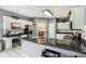 Bright kitchen with granite countertops, white cabinets, stainless steel appliances, and adjacent dining area at 7323 Elm Ridge Dr, Indianapolis, IN 46236