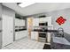 Charming kitchen boasts white cabinets, granite counters, and stainless appliances, with bright natural light at 7323 Elm Ridge Dr, Indianapolis, IN 46236