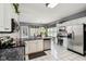 Modern kitchen with granite countertops, stainless steel appliances, and a view to the dining area at 7323 Elm Ridge Dr, Indianapolis, IN 46236