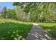 Scenic community path through lush greenery and shade trees on a sunny day at 7323 Elm Ridge Dr, Indianapolis, IN 46236