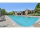 Community pool featuring clear blue water, lounge chairs, and a pool house surrounded by lush landscaping and lawns at 7323 Elm Ridge Dr, Indianapolis, IN 46236