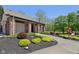 Pool house with brick pillars and landscaping with colorful plantings, mulch beds and an orange book drop box at 7323 Elm Ridge Dr, Indianapolis, IN 46236
