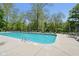 Community pool with clear water, lounge chairs, and umbrellas on a sunny day at 7323 Elm Ridge Dr, Indianapolis, IN 46236