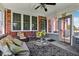 Charming sunroom with brick accents, comfortable seating, and access to the backyard at 7323 Elm Ridge Dr, Indianapolis, IN 46236