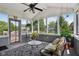 Inviting sunroom with screened windows, stylish seating, and views of the outdoor landscape at 7323 Elm Ridge Dr, Indianapolis, IN 46236