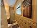 A classic bathroom has a tiled wall, walk-in shower, framed art, and fixtures at 7334 E 14Th St, Indianapolis, IN 46219
