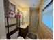 A bathroom including a shower, framed art, cabinet storage, sink, and fixtures at 7334 E 14Th St, Indianapolis, IN 46219