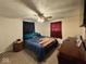 A bedroom with a ceiling fan, dark curtains, and a bed with an American flag blanket at 7334 E 14Th St, Indianapolis, IN 46219
