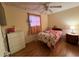 Cozy bedroom with hardwood floors, a comfortable single bed, and soft lighting, creating a peaceful retreat at 7334 E 14Th St, Indianapolis, IN 46219
