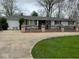 Lovely ranch home with charming brickwork, manicured lawn, and convenient access to an attached two car garage at 7334 E 14Th St, Indianapolis, IN 46219