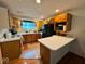 Functional kitchen with wood cabinets, black appliances, and an efficient layout for easy meal preparation at 7334 E 14Th St, Indianapolis, IN 46219