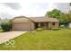 Charming single story home with a well maintained lawn, attached garage and welcoming front porch at 7450 Cobblestone W Dr, Indianapolis, IN 46236