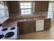 Close up of the kitchen featuring wooden cabinets, neutral countertops, and modern appliances at 7450 Cobblestone W Dr, Indianapolis, IN 46236