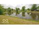 Scenic view of the pond, with trees reflected in the water at 7450 Cobblestone W Dr, Indianapolis, IN 46236
