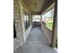 Covered stone porch with railing and an overhead light at 7450 Cobblestone W Dr, Indianapolis, IN 46236