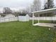 Spacious backyard with a storage shed, carport, and plenty of green grass at 823 N Noble St, Greenfield, IN 46140