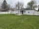 Backyard of home, with grass, a small patio, and a white picket fence at 823 N Noble St, Greenfield, IN 46140