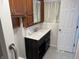 Bathroom vanity with a white sink, dark wood cabinets, and a window at 823 N Noble St, Greenfield, IN 46140