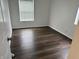 Bedroom has neutral walls, wood floors, and a bright window at 823 N Noble St, Greenfield, IN 46140