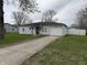 Charming single-story home with a one-car garage and a well-maintained lawn at 823 N Noble St, Greenfield, IN 46140