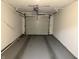 Interior of garage showing garage door, freshly painted walls, and epoxy floor at 823 N Noble St, Greenfield, IN 46140